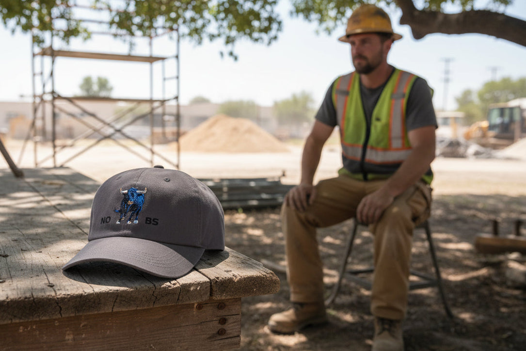 Dark grey hat with a blue bull graphic and 'NO BS' text - 100% cotton