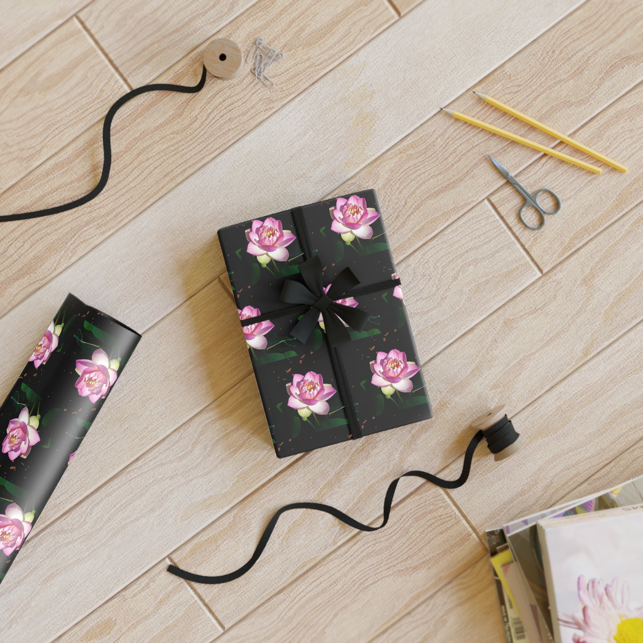 Gift Wrapping in silky, lux fine art paper to wow with pink lotus blossoms on black background
