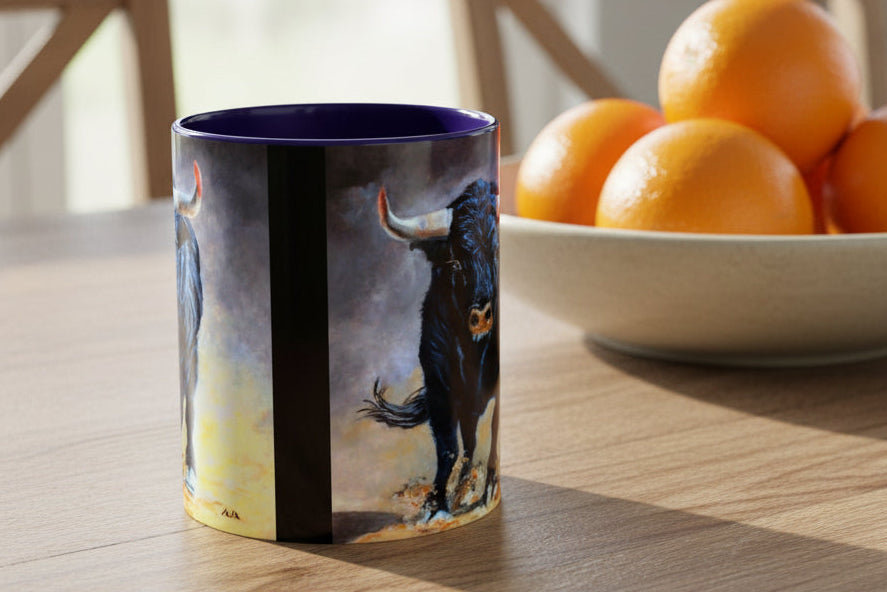 Mug with blue interior and handle shows both sides have artist painting of charging bull