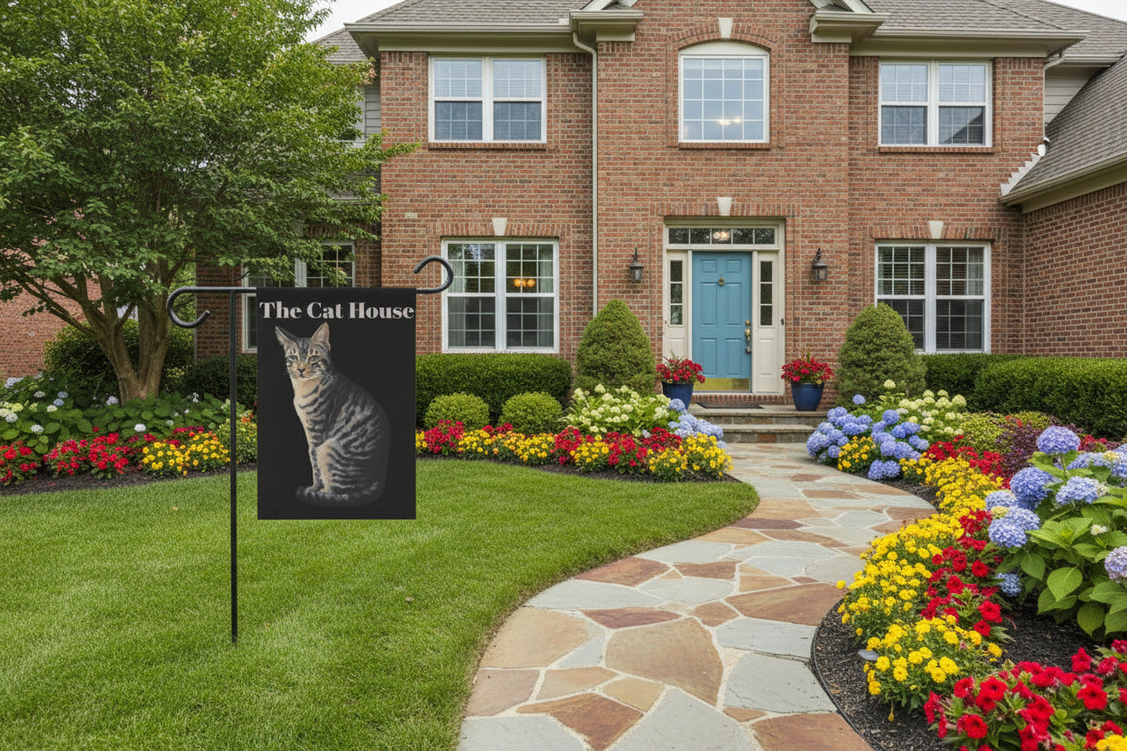 Flag with a cat design and 'The Cat House' text on a black background