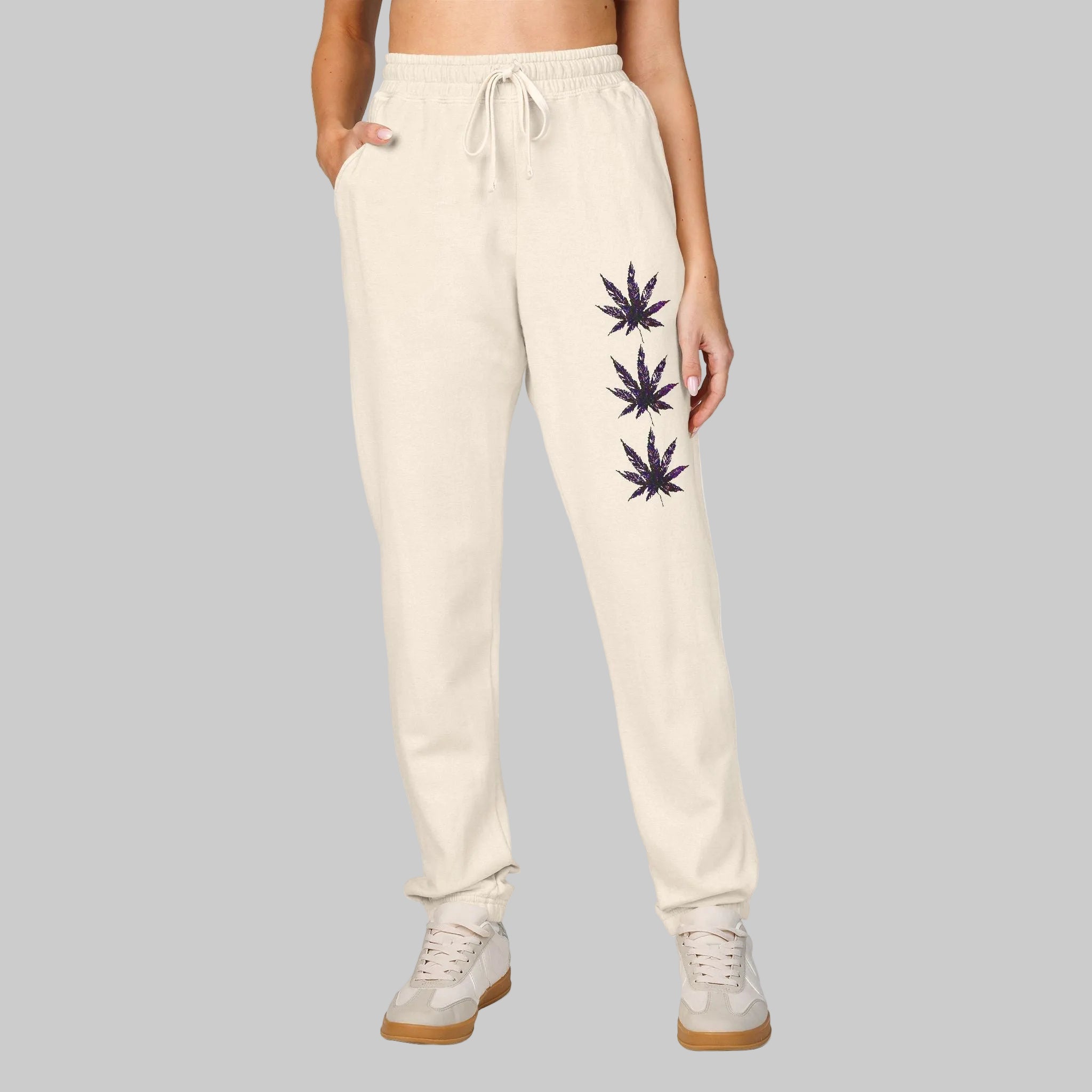 Ivory women's and men's sweatpants with a marijuana leaf graphic stating your culture to relax in all day