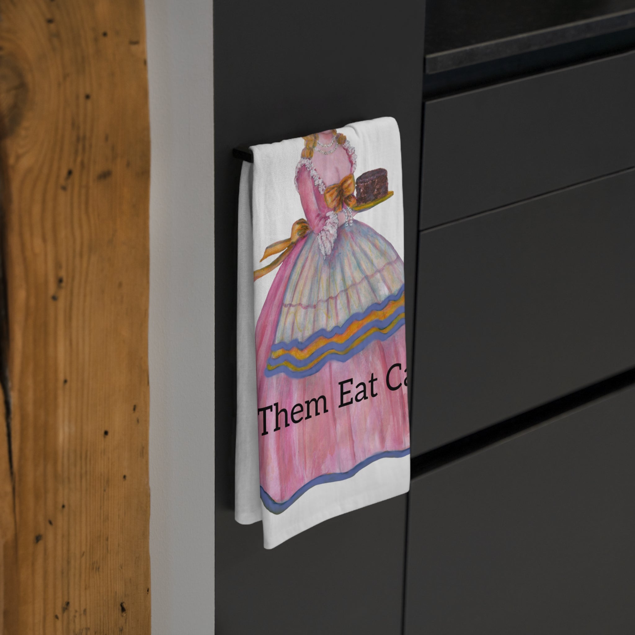 Towel with a colorful vintage illustration hanging on a black cabinet. This Towel is an Excellent Hostess Gift.