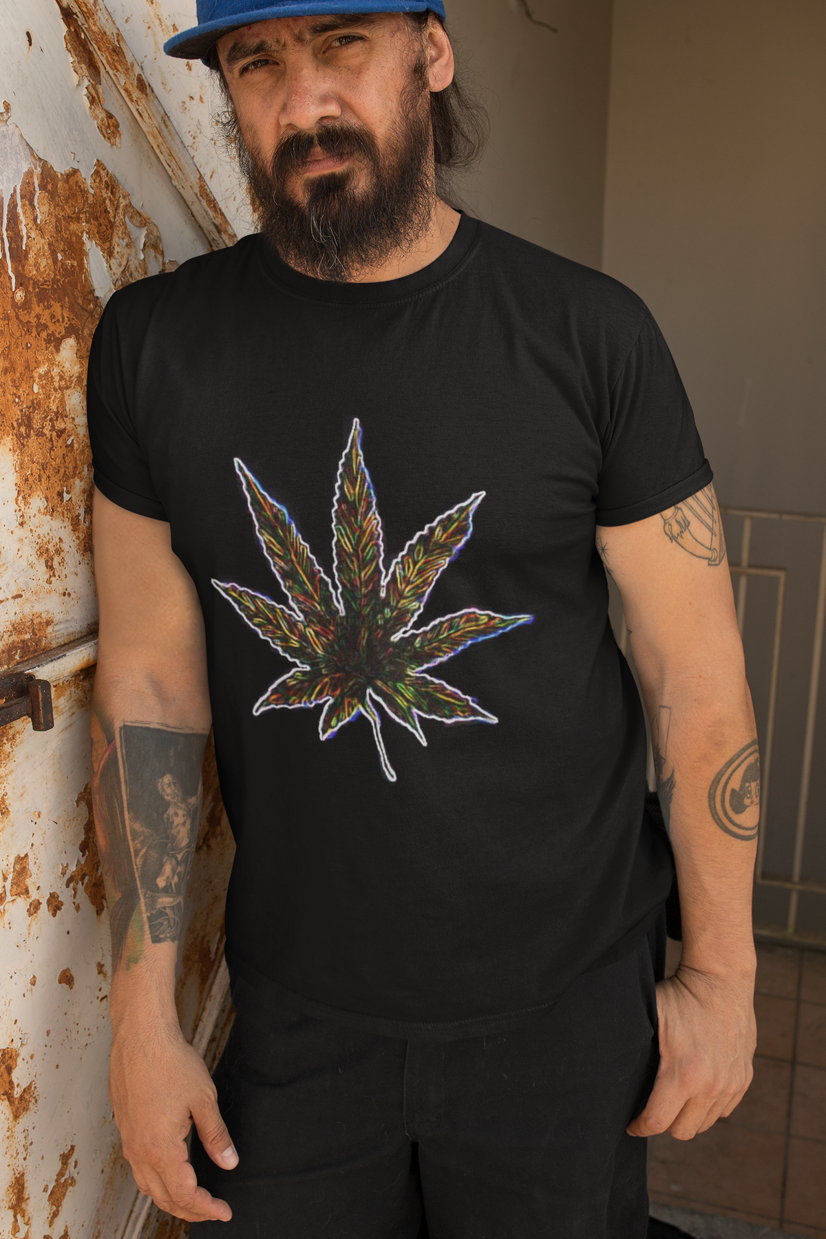 Man wearing a black t-shirt with a colorful cannabis leaf design in ring-spun cotton - classic fit