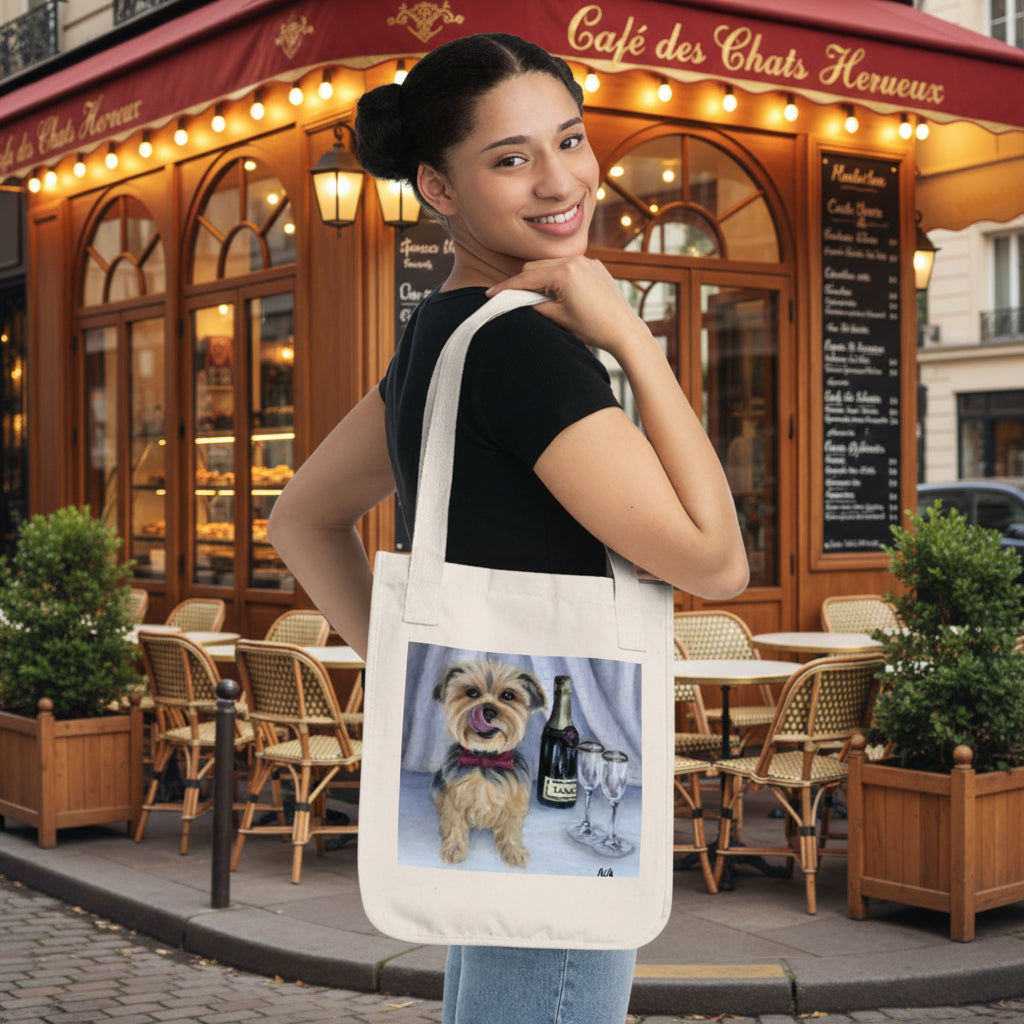  Natural canvas tote bag  The bag features a printed graphic of a small tan dog sitting next to a bottle and two wine glasses.