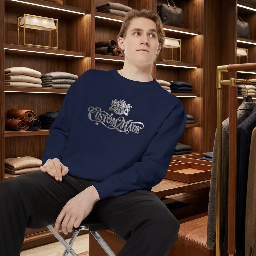 A man wearing a navy blue crewneck sweatshirt with a silver 'Custom Made' graphic