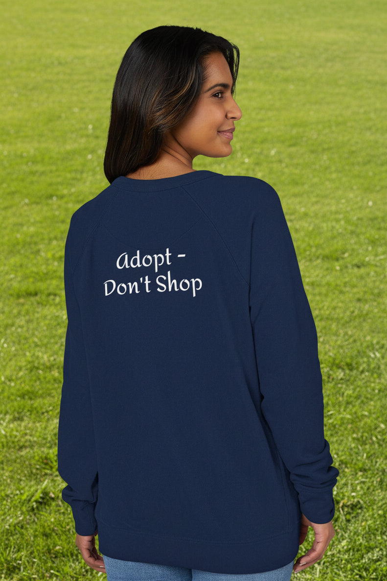 Person wearing a navy blue long-sleeve raglan shirt with 'Adopt Don't Shop' text on the back. S-3XL