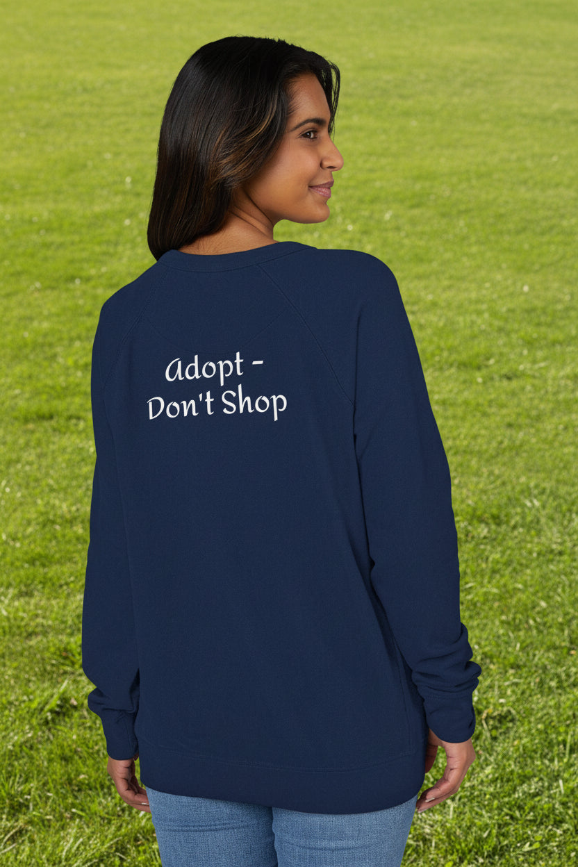 Person wearing a navy blue long-sleeve raglan shirt with 'Adopt Don't Shop' text on the back.