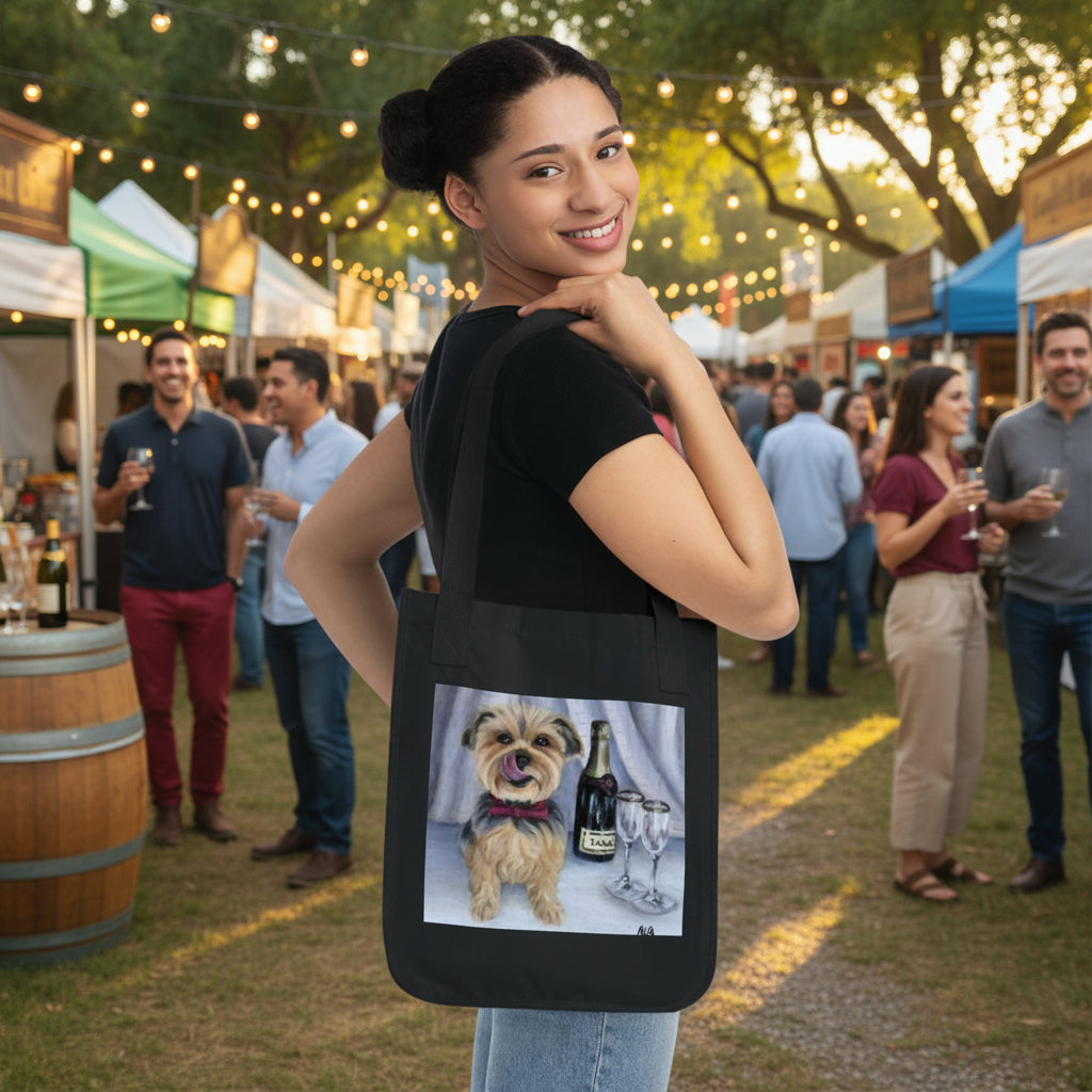 Organic black canvas tote bag  features a printed graphic of a small tan dog sitting next to a bottle and a wine glass.