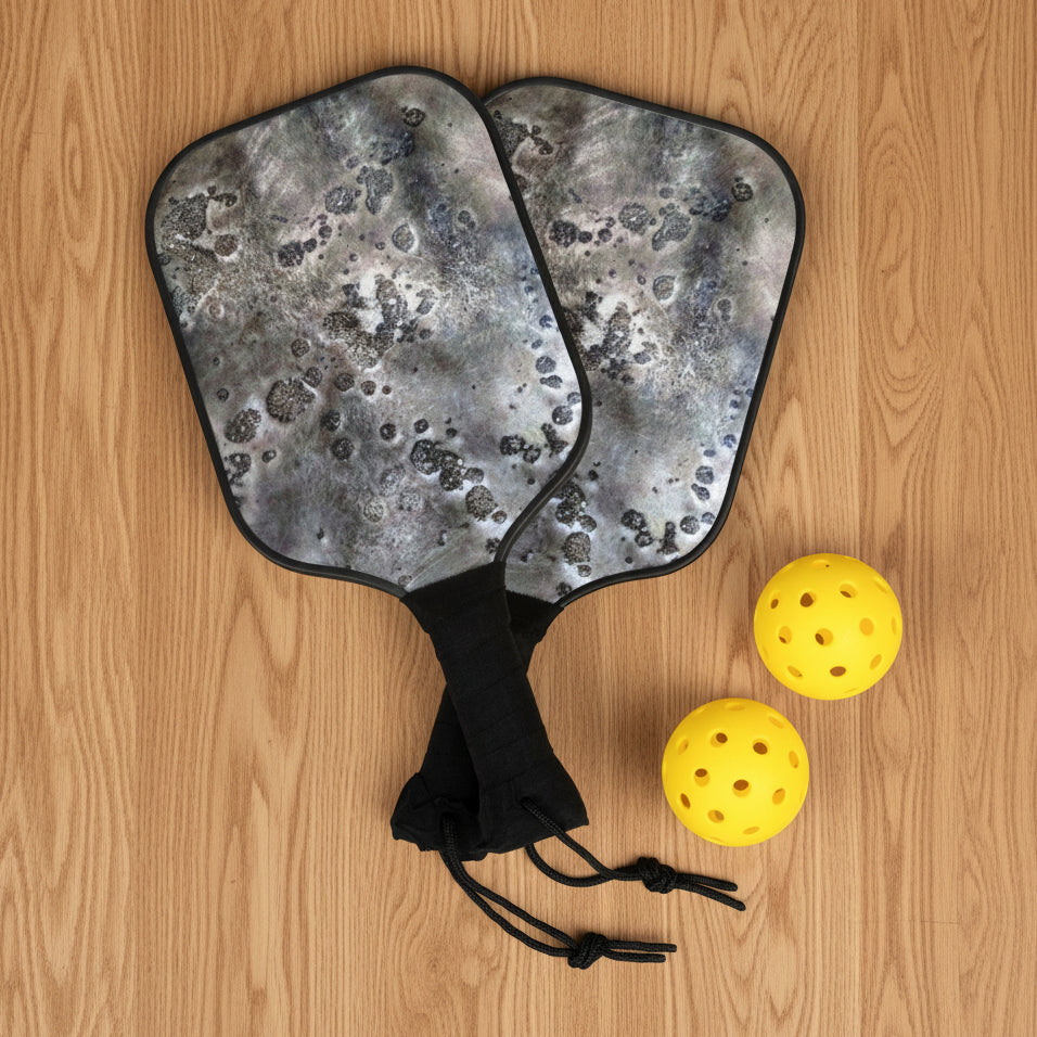 Wooden pickleball paddles with Moon Rock Design with a drawstring bag and three yellow pickleballs 