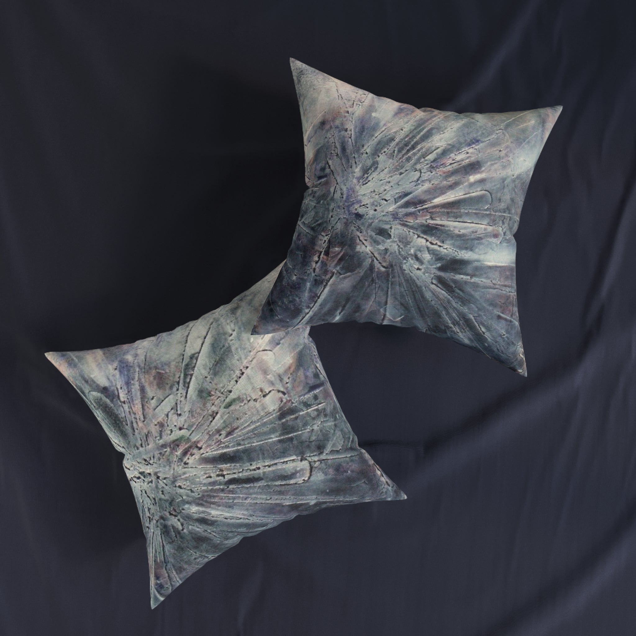 Decorative pillows with a striking abstract burst of silver