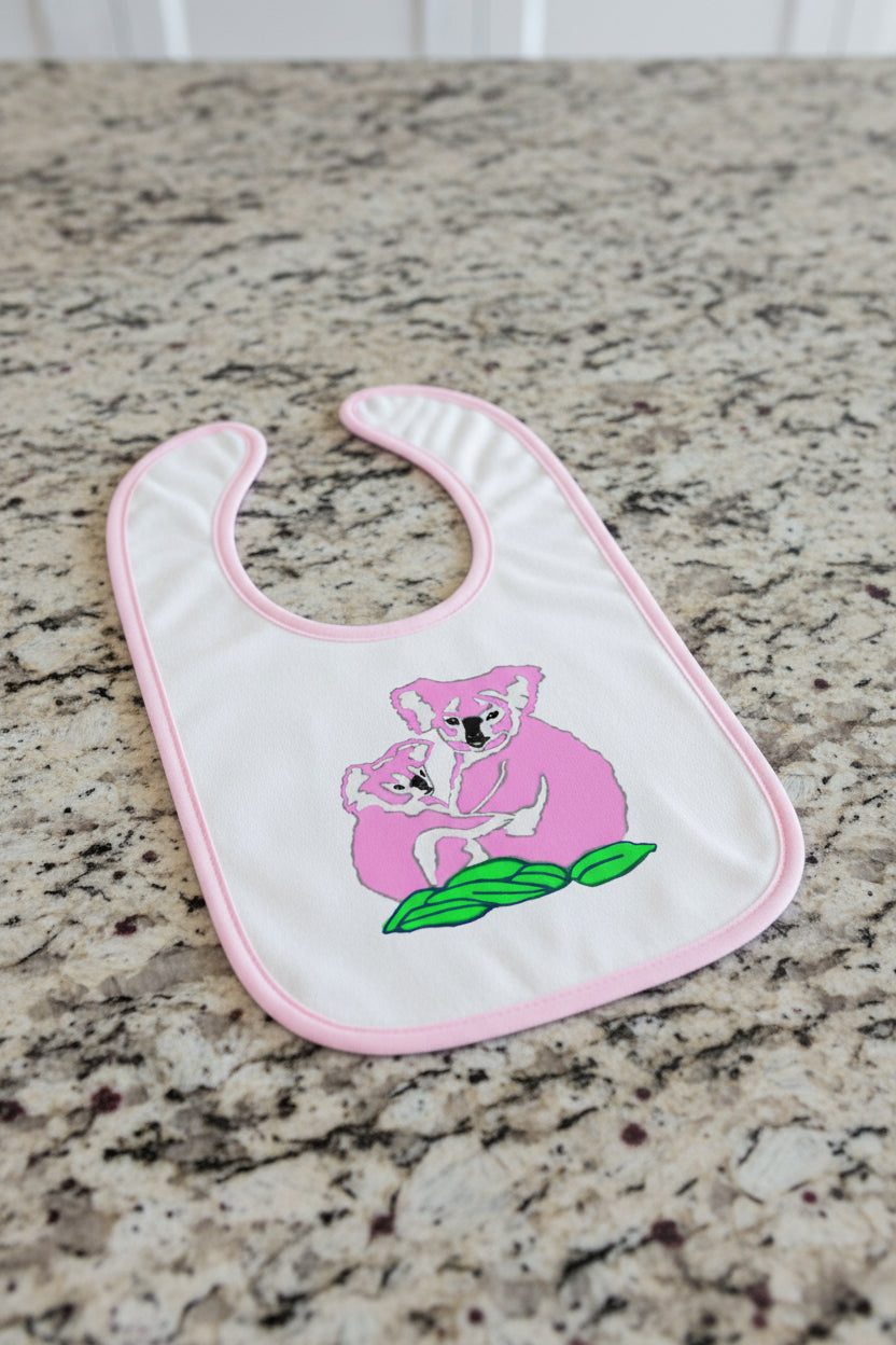 Baby bib with pink koala design on a white background