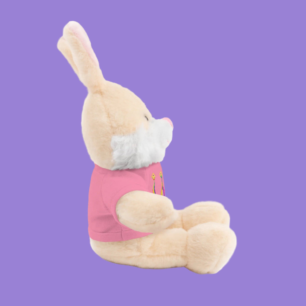 Side view of Plush toy rabbit wearing a pink tee 