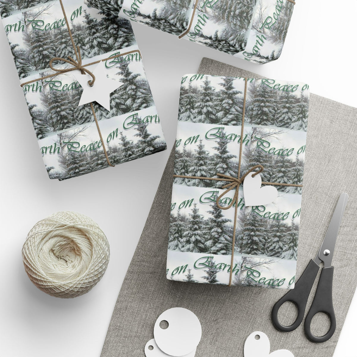 Gift wrap with snowy pine forest and text Peace on Earth