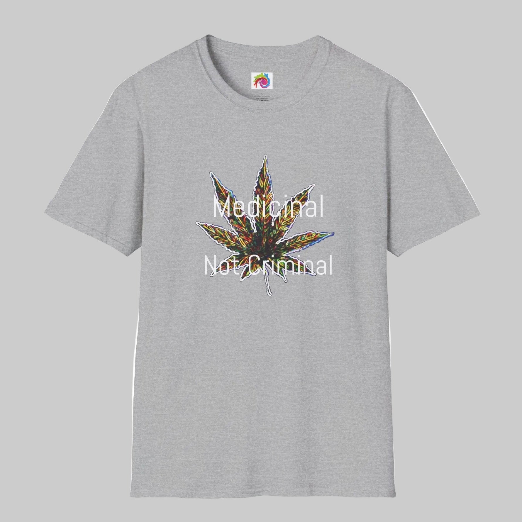 A light gray crewneck t-shirt featuring a central graphic of a cannabis leaf with a colorful, textured pattern and the text 'Medicinal Not Criminal' printed in white across it.