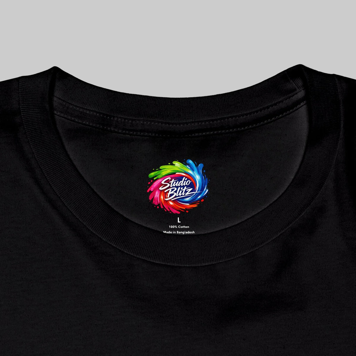 Close-up of a black crewneck t-shirt showing the inside collar with a colorful 'Studio Blitz' logo printed on it.