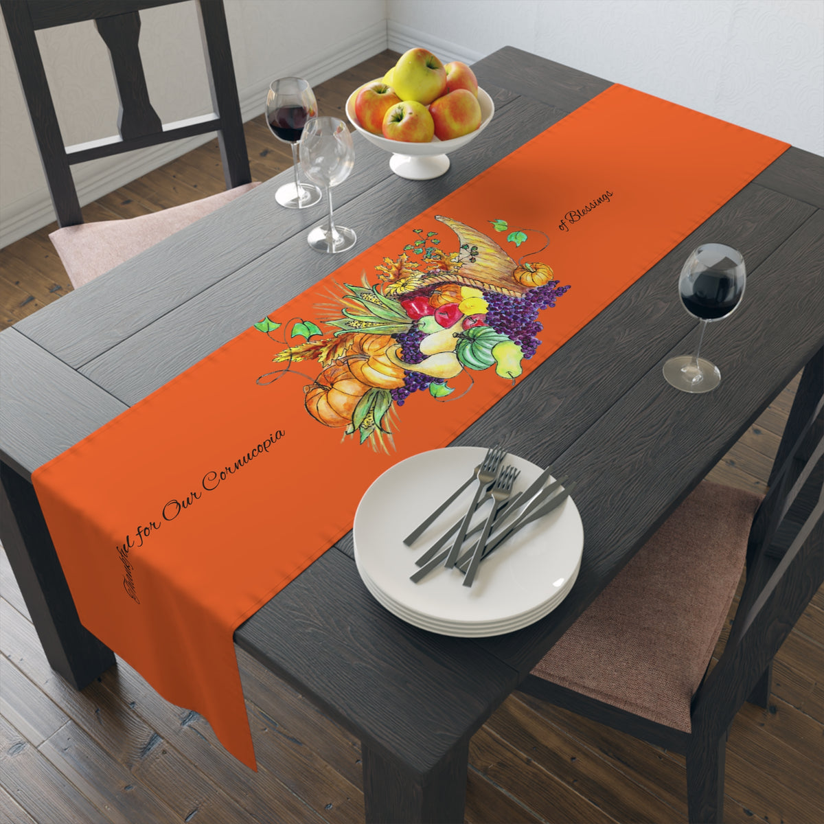 Orange table runner featuring a painted harvest cornucopia design and text