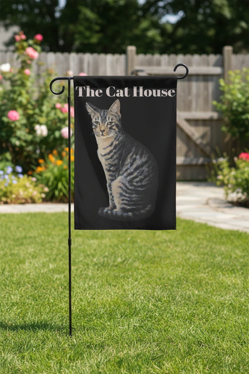 Yard flag with a cat illustration and 'The Cat House' text on a black background