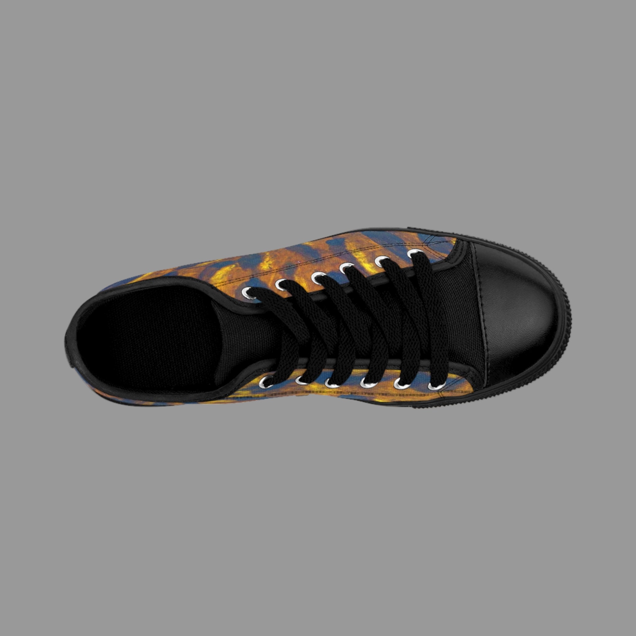 Black sneaker with a patterned sole on a light background