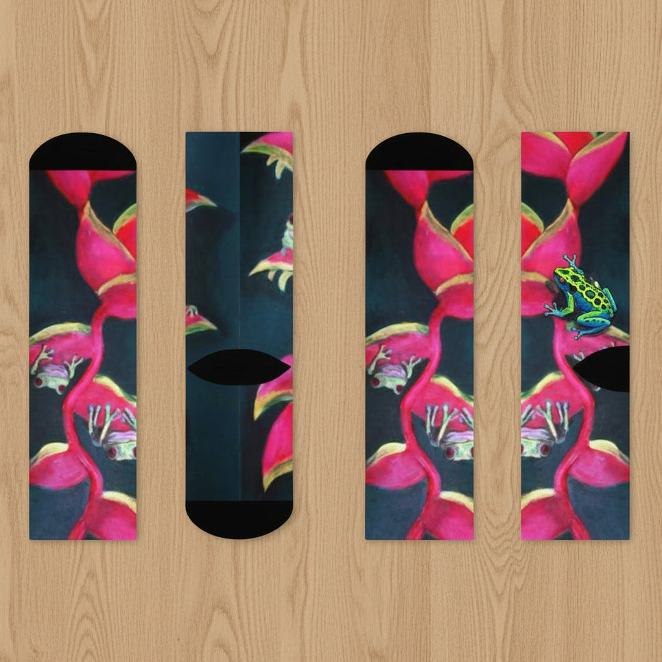 Four socks with pink Heliconia plant and frogs design on a black stretchy, cozy material shows top and bottom