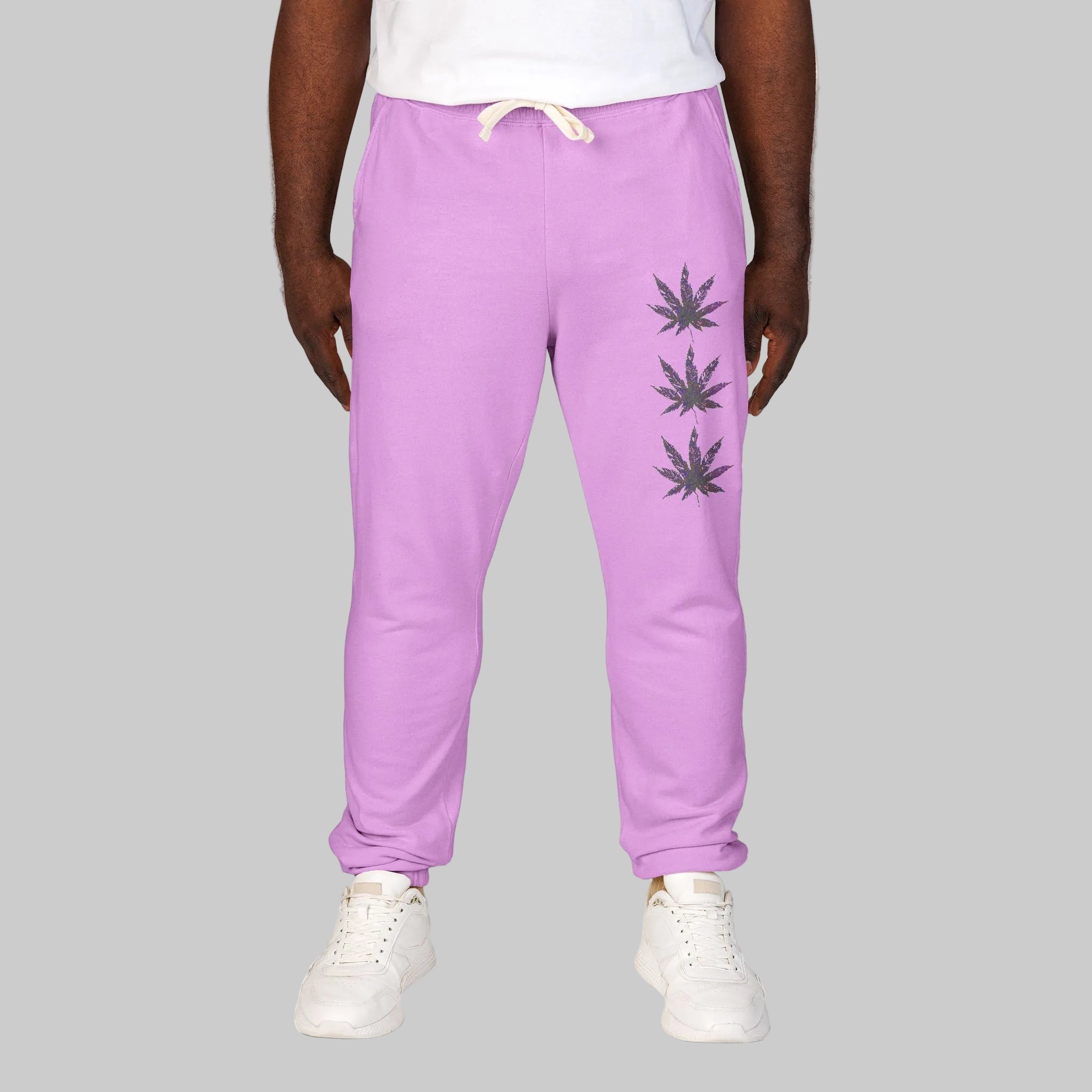 Vibrant Neon Violet sweatpants with three  cannabis leaf graphics printed vertically on the left leg in soft, durable cotton