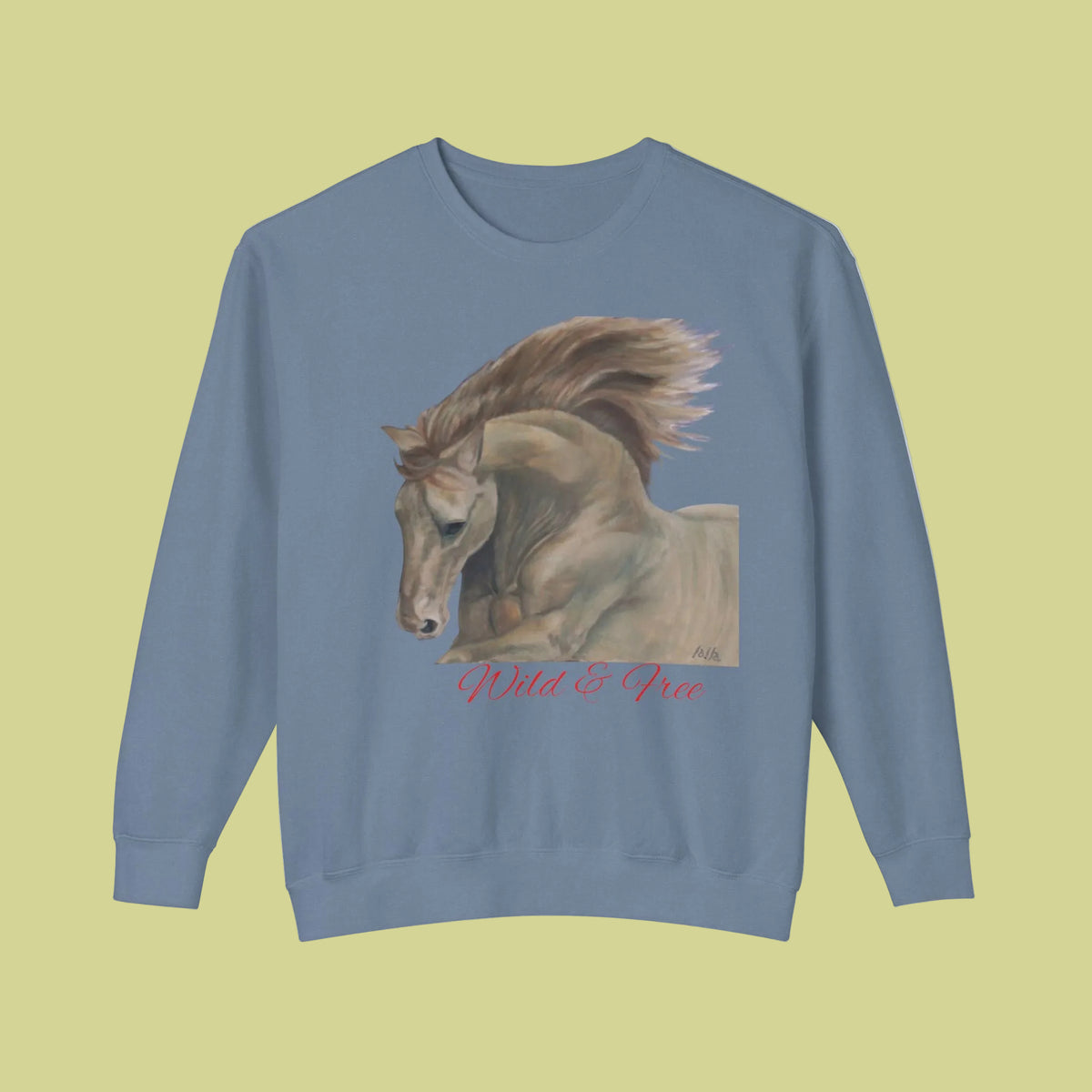 A blue jean crewneck sweatshirt featuring a graphic print of a horse with the text 'Wild & Free' in red cursive below it - available in 4 colors