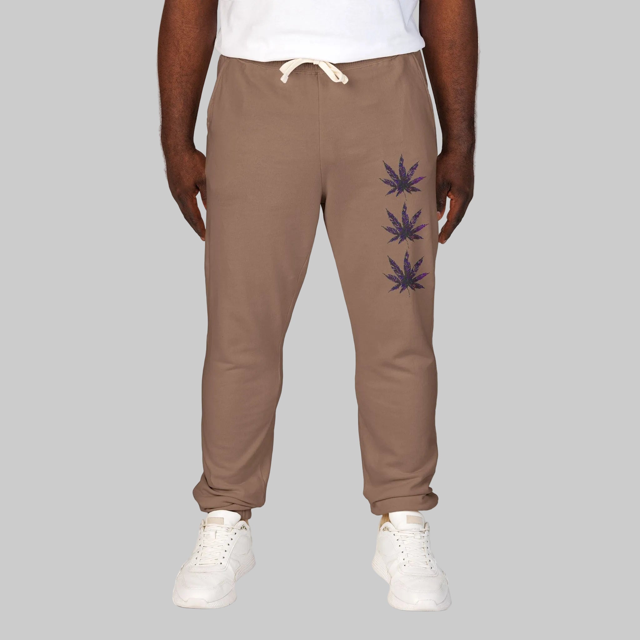 Espresso colored jogger/lounging sweatpants with a white drawstring, featuring a vertical stack of three dark cannabis leaf graphics on the left leg S-2XL