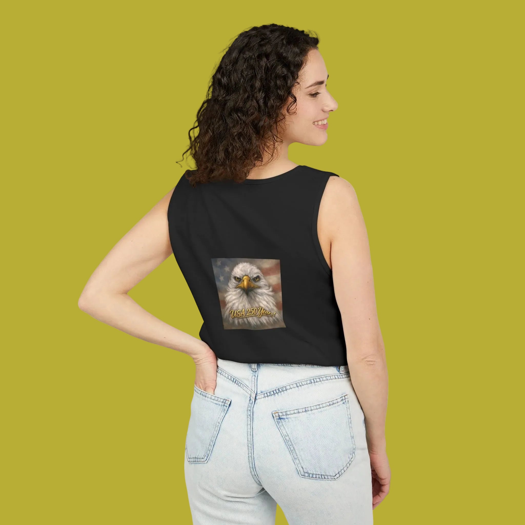 Woman wearing a black tank top with an eagle painting on the BACK