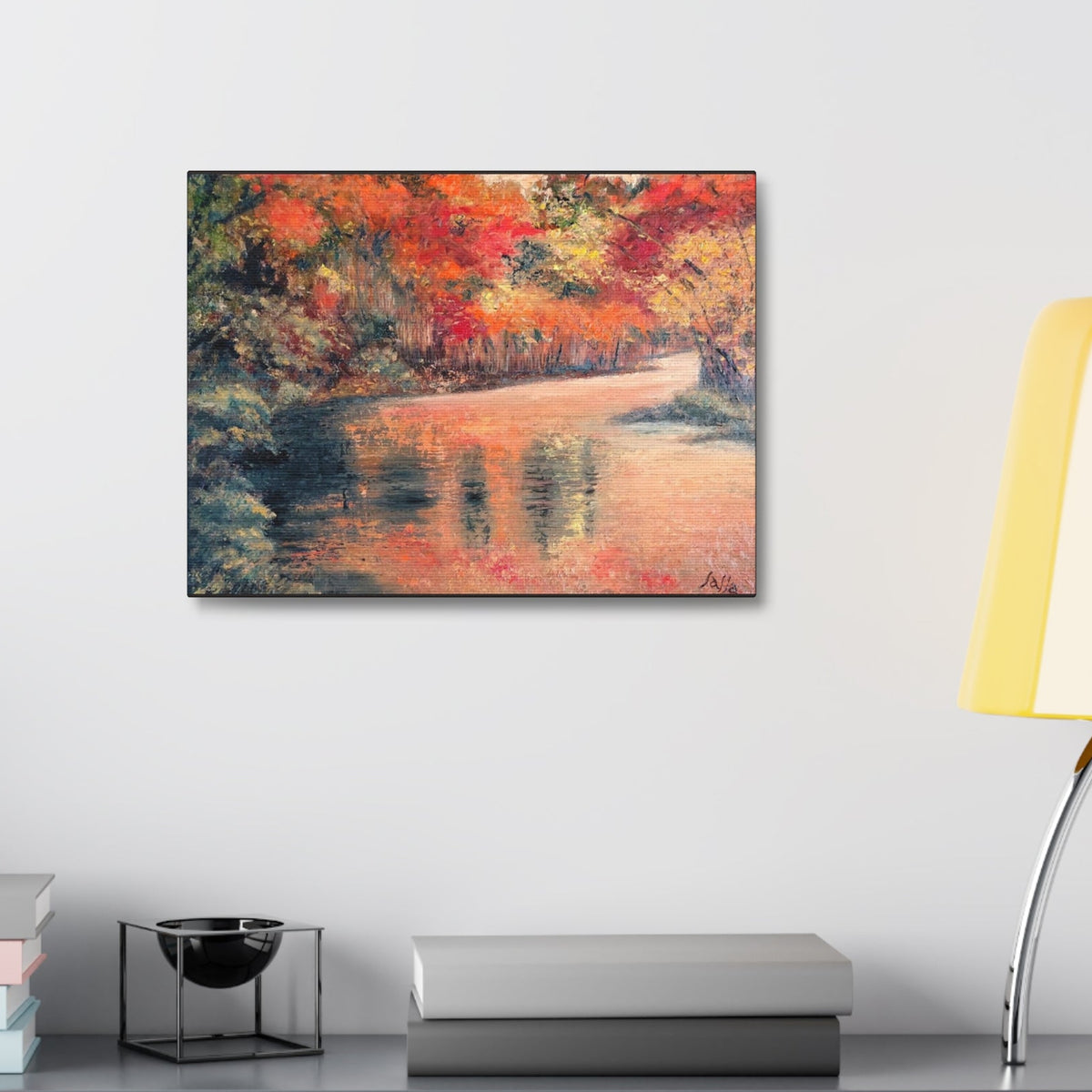 A rectangular canvas painting of an autumn landscape with a reflective river and colorful trees available in two sizes