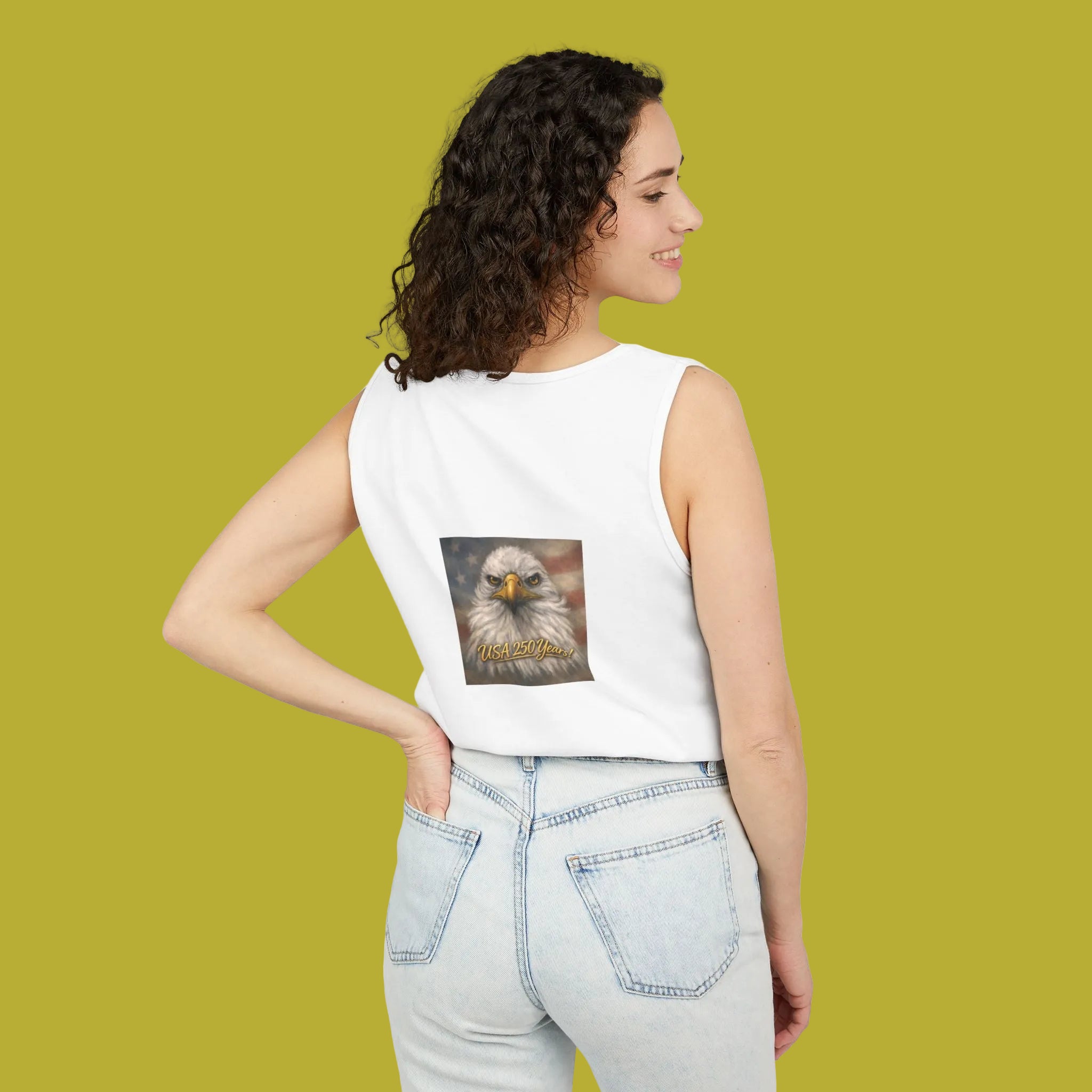Woman wearing a white tank top with an eagle graphic and USA 250 yrs!