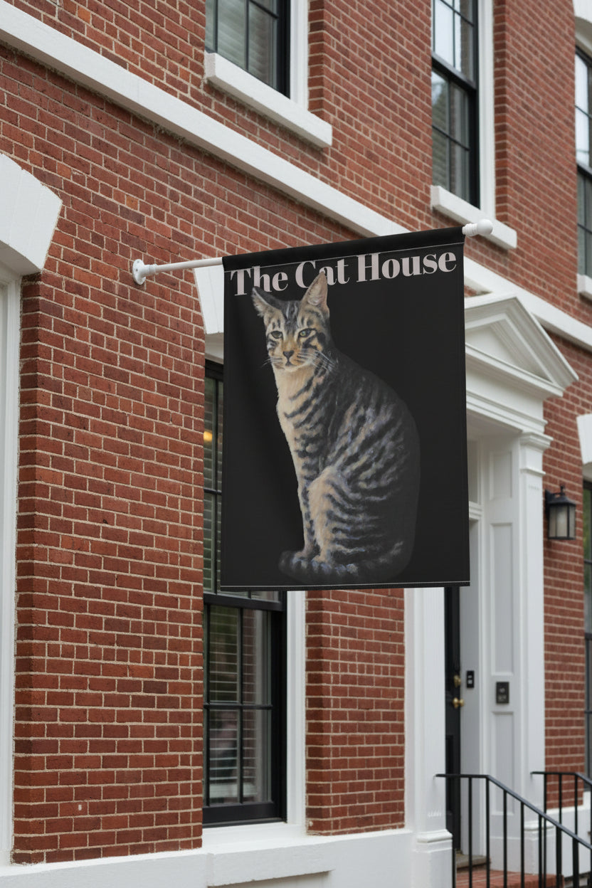 Flag with a cat design and 'The Cat House' text on a black background