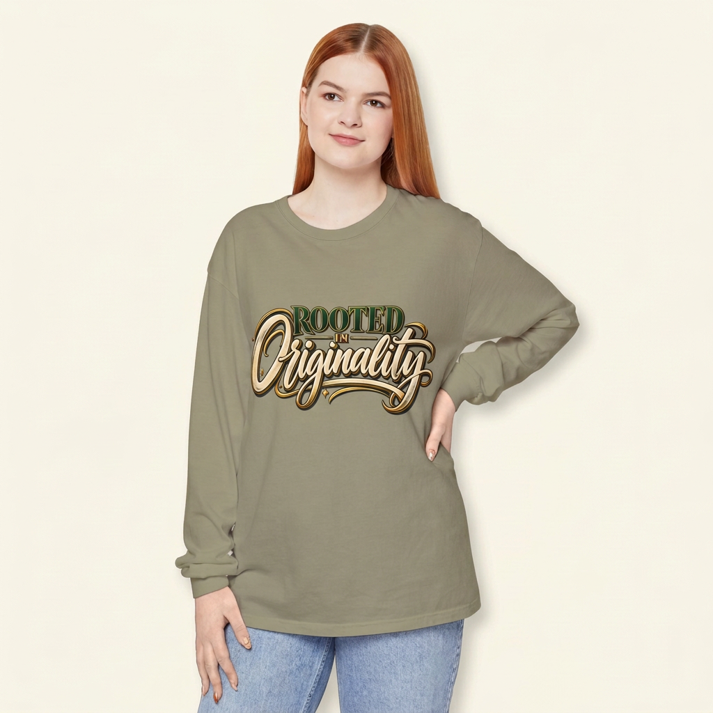 Red-haired woman wearing a muted sage Rooted in Originality long-sleeve tee, hand on hip.