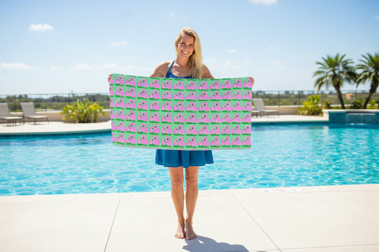Green hooded towel with pink koala pattern on a white background